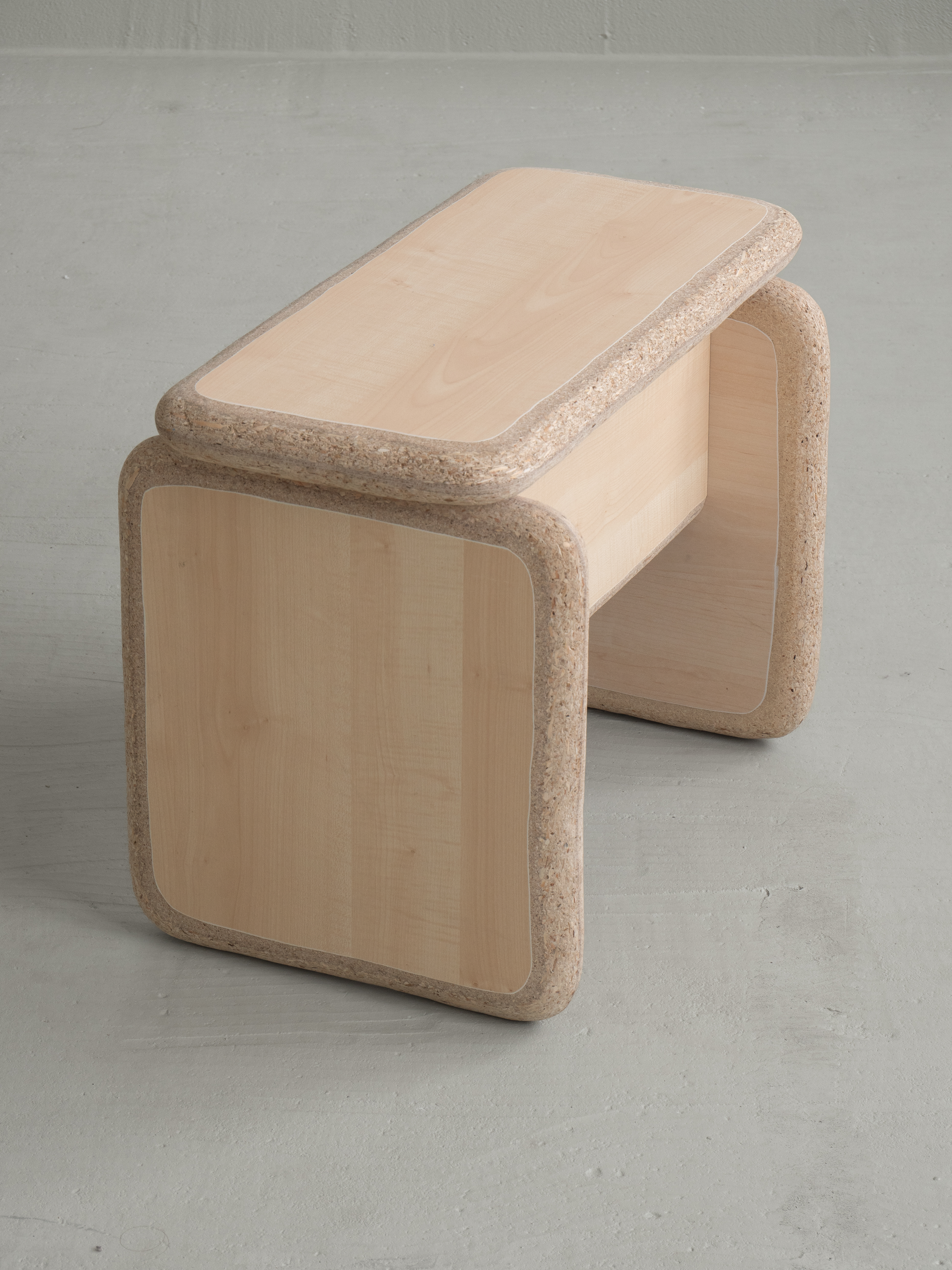 stool made of light wood with rounded corners