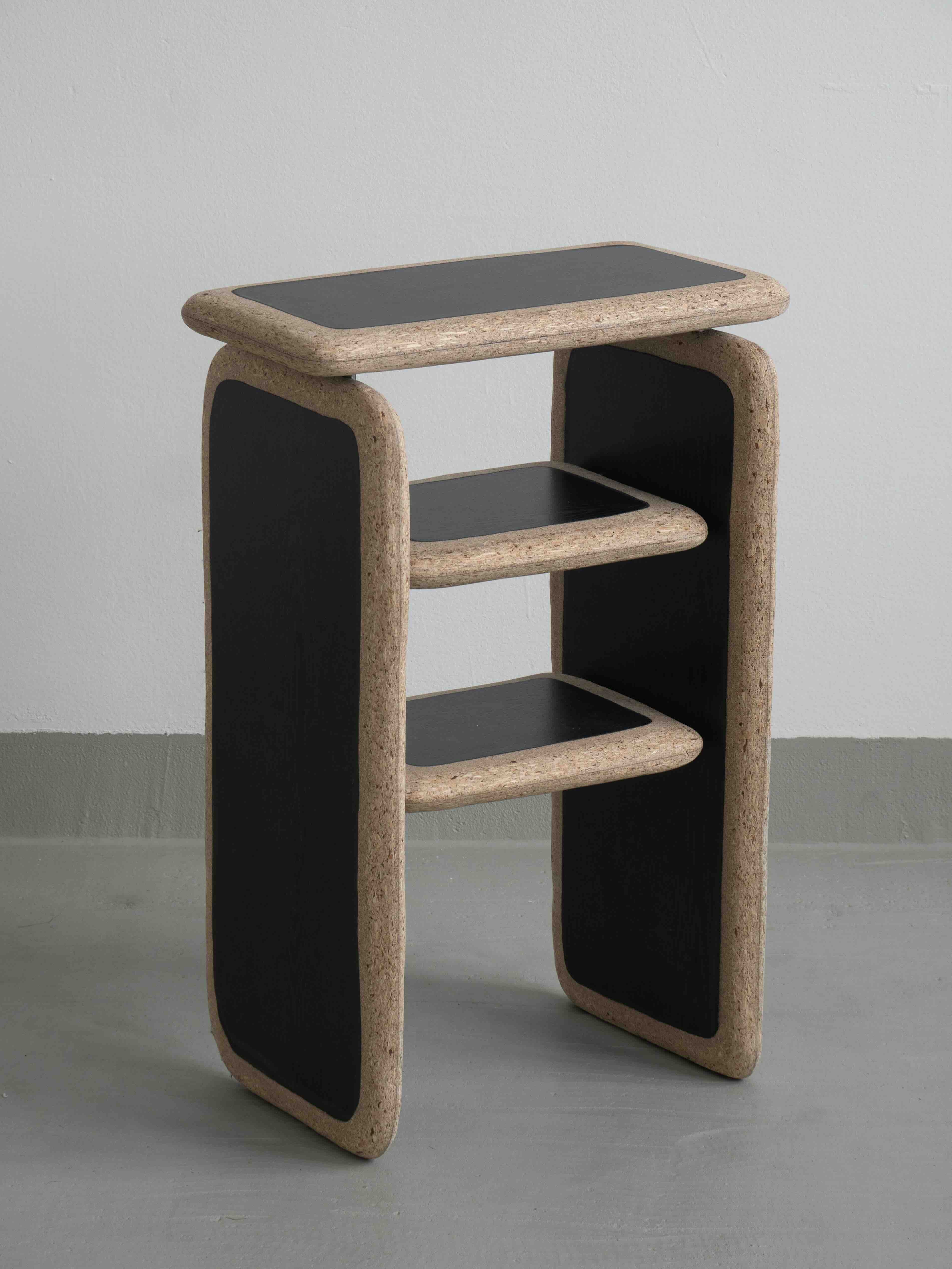 stool made of dark wood laminate with rounded corners